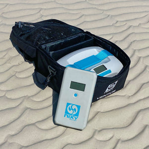 sup pump and battery pack on the sand of a beach