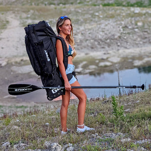 Women carrying an inflatable paddleboard in a NIXY waterproof isup backpack