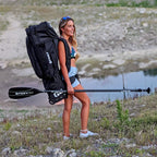 Women carrying an inflatable paddleboard in a NIXY waterproof isup backpack